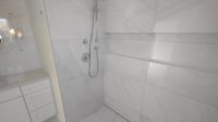 luxury bathroom install using white large-format tile